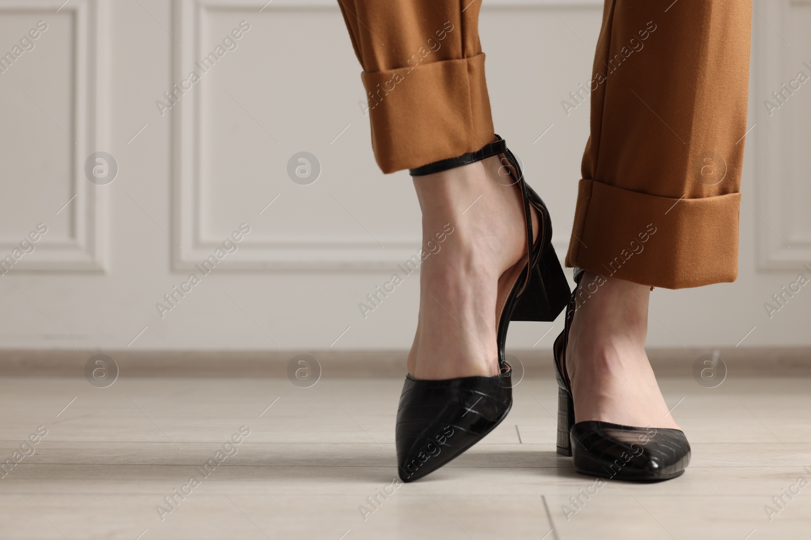 Photo of Businesswoman in elegant leather shoes indoors, closeup. Space for text