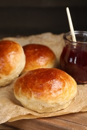 Tasty scones prepared on soda water and jam on wooden table