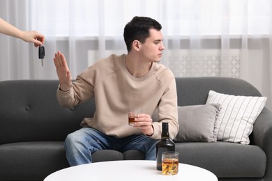 Drunk man refusing drive car while woman suggesting him keys, closeup. Don't drink and drive concept