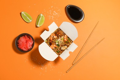 Photo of Noodle wok served on orange background, flat lay