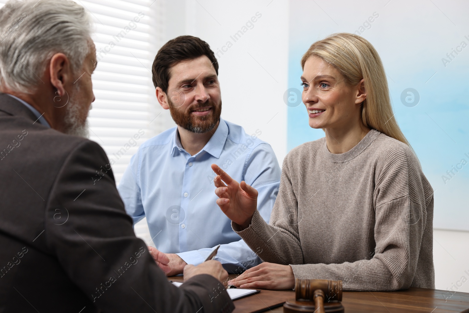 Photo of Couple having meeting with lawyer in office