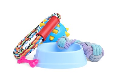 Feeding bowl and toys for pet on white background