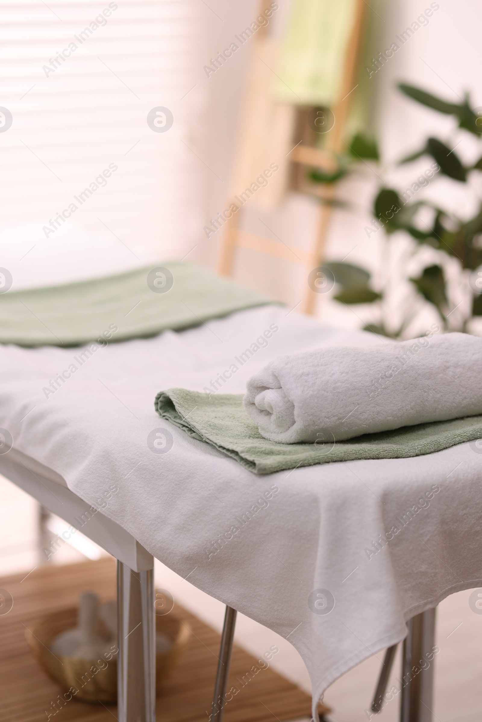 Photo of Rolled towel on massage table in spa center