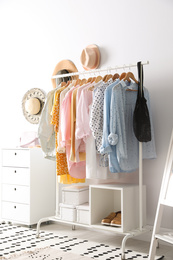 Rack with stylish women's clothes indoors. Interior design