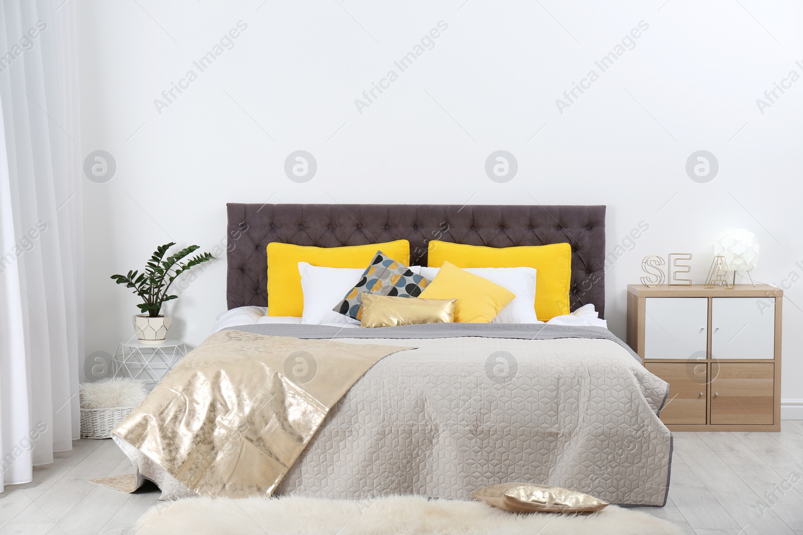 Photo of Stylish room interior with large comfortable bed