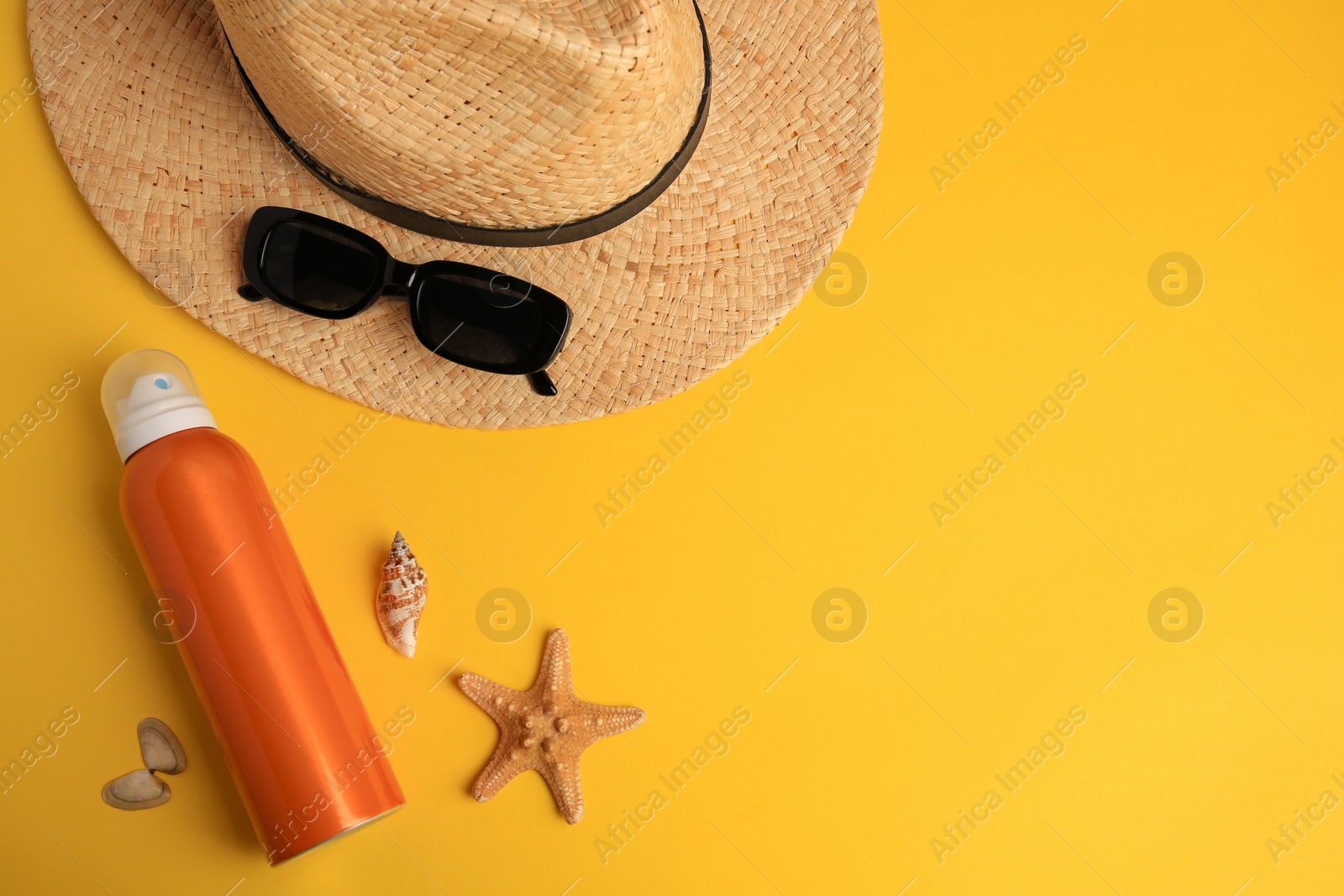 Photo of Flat lay composition with bottle of sunscreen on yellow background. Space for text
