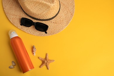 Flat lay composition with bottle of sunscreen on yellow background. Space for text