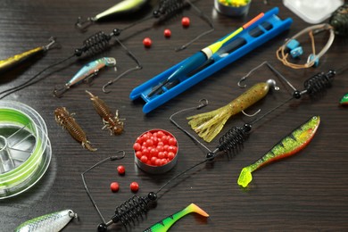 Photo of Fishing tackle on dark wooden background, closeup