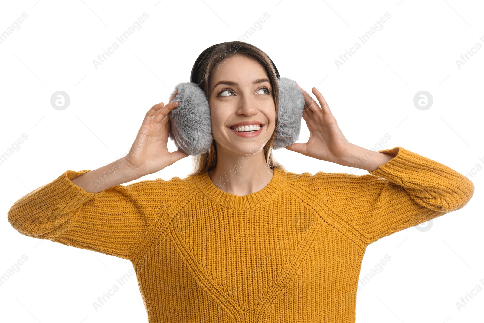 Photo of Happy woman wearing warm earmuffs on white background