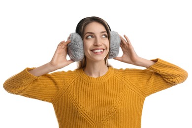 Photo of Happy woman wearing warm earmuffs on white background