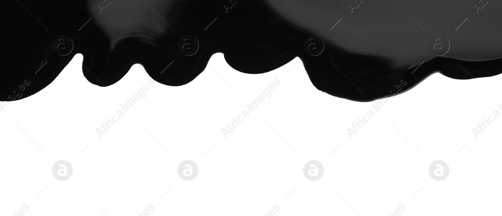 Photo of Black viscous liquid flowing on white background