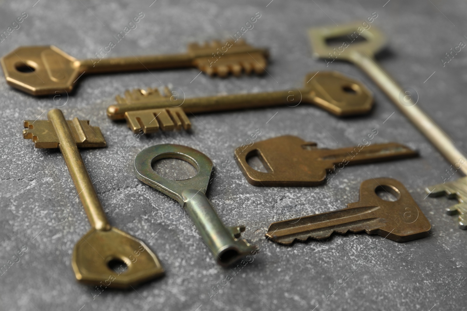 Photo of Steel keys on grey background, closeup. Safety concept