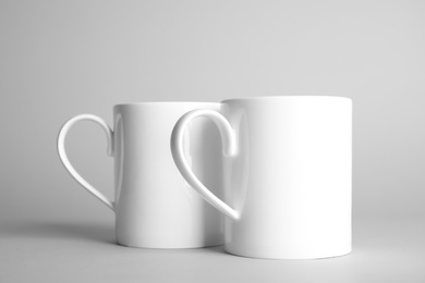 Ceramic cups on light background. Mock up for design