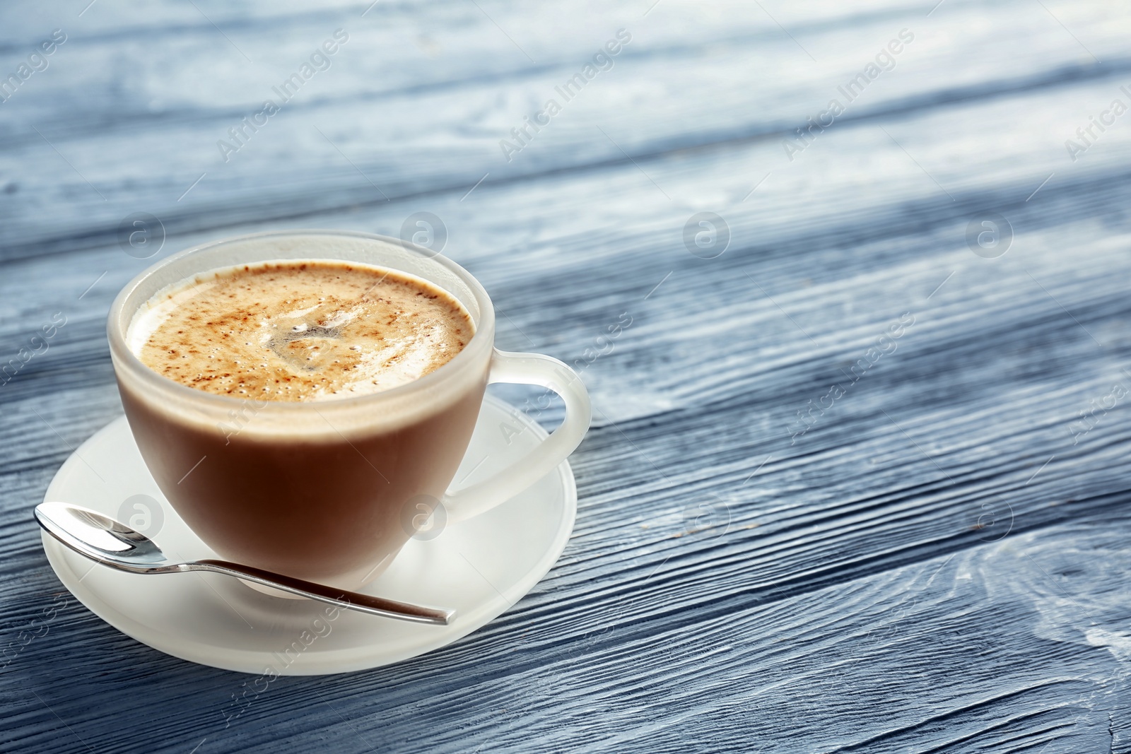 Photo of Cup of aromatic hot coffee on wooden background