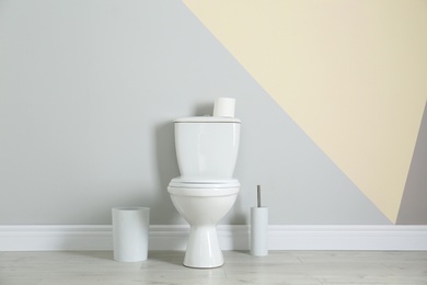 Photo of Simple bathroom interior with new toilet bowl near color wall