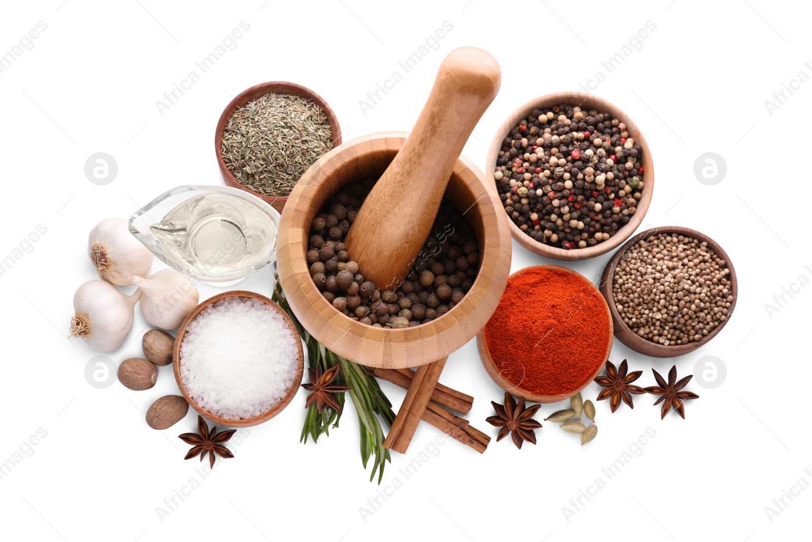 Photo of Mortar with pestle and different spices on white background, top view