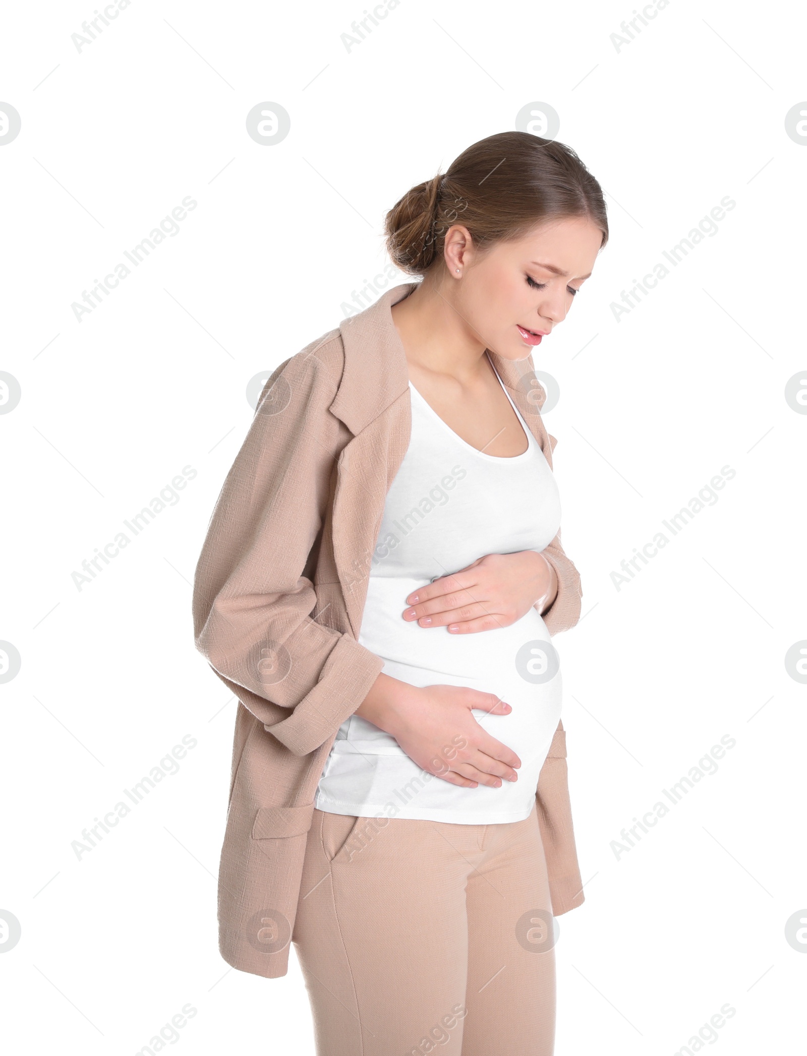 Photo of Young pregnant woman suffering from pain on white background. Working while expecting baby