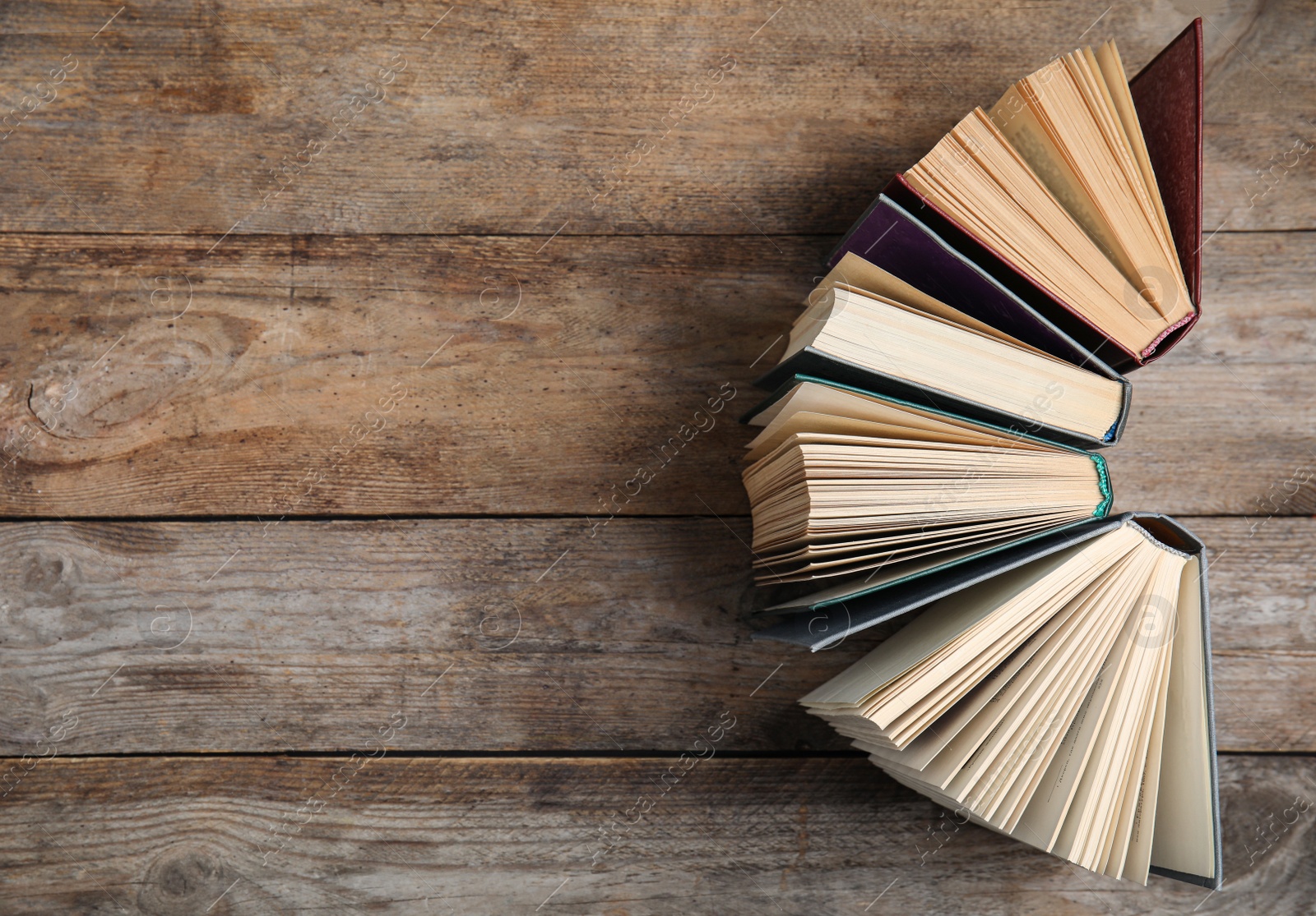 Photo of Hardcover books on wooden background, flat lay