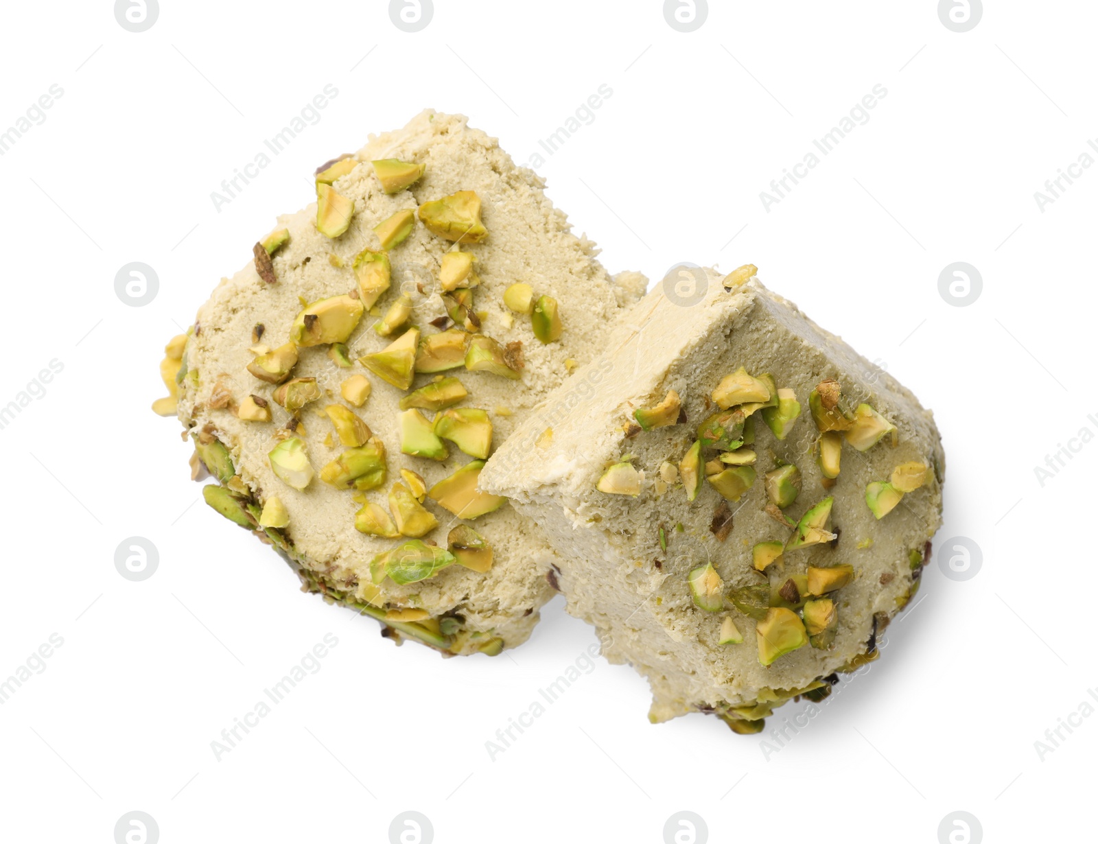 Photo of Pieces of tasty halva with pistachios on white background, top view