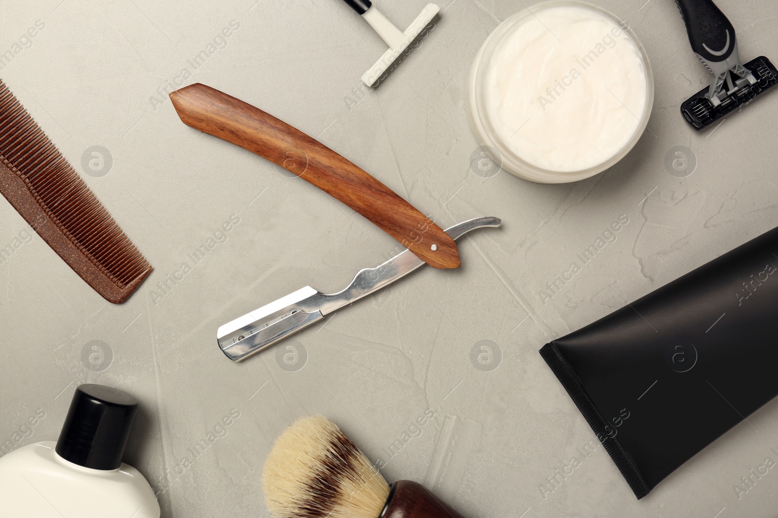 Photo of Set of men's shaving tools on light gray table, flat lay