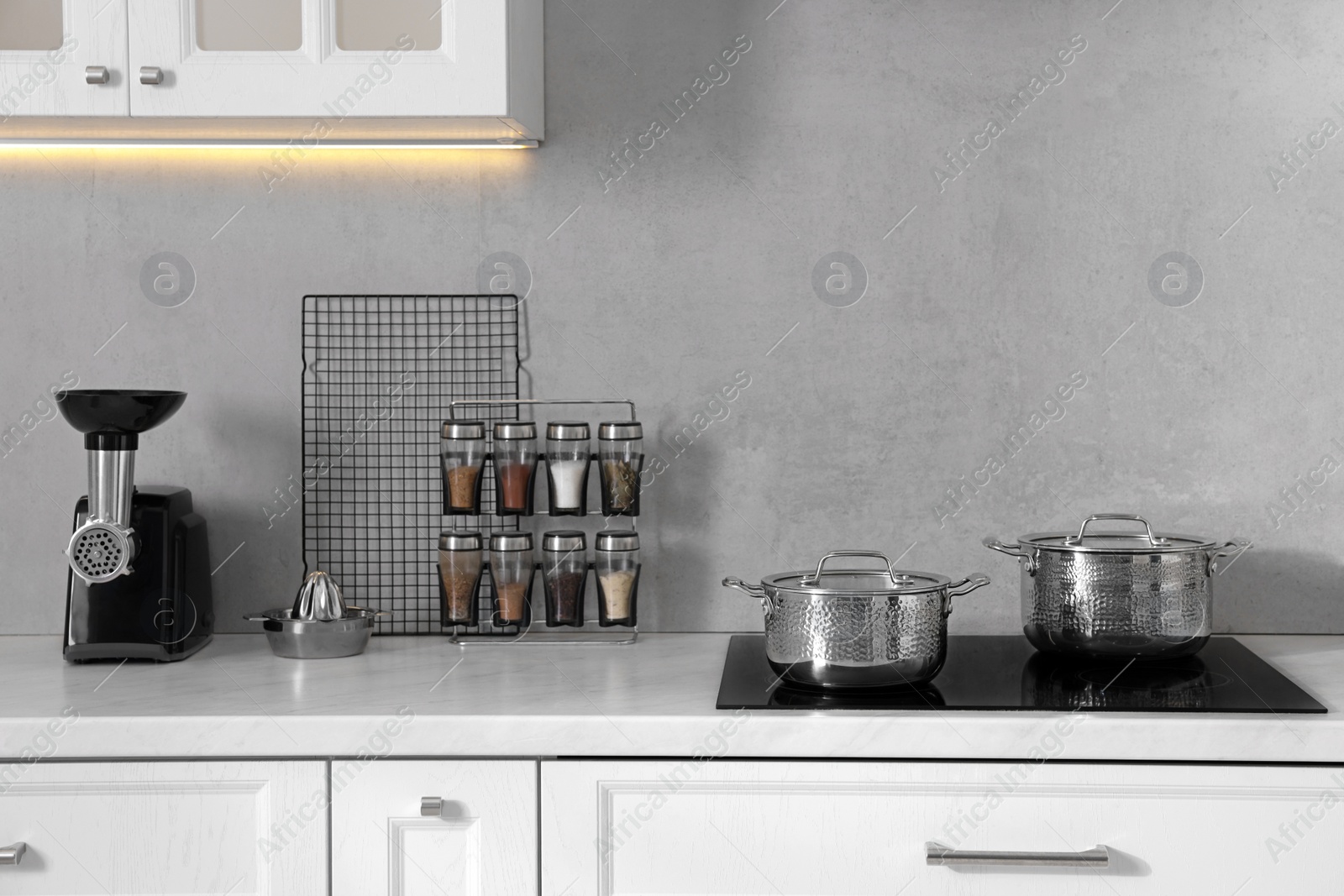 Photo of Set of different utensils on countertop in kitchen