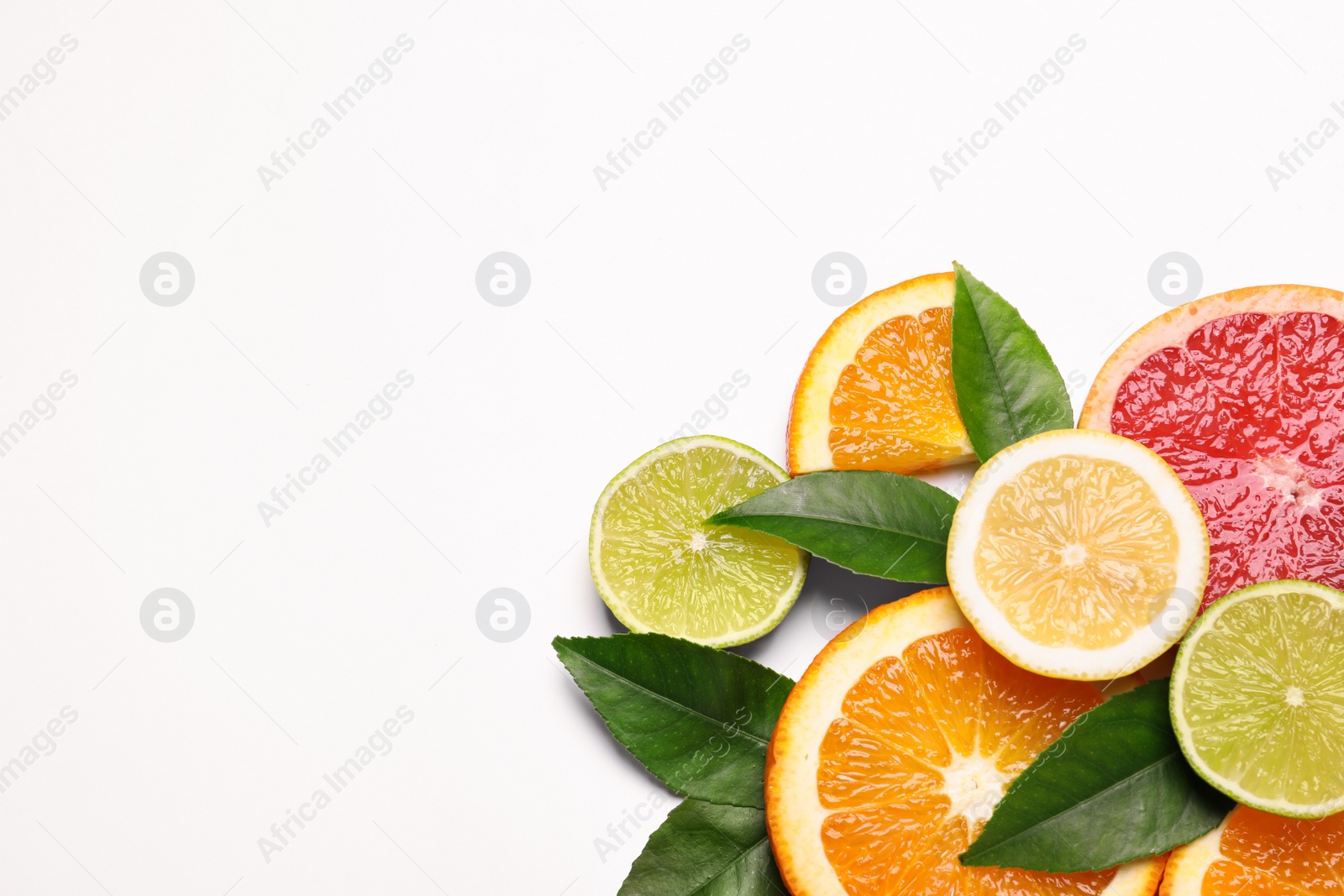 Photo of Fresh juicy citrus fruits with green leaves on white background, flat lay. Space for text