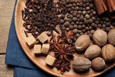 Different spices and nuts on table, top view