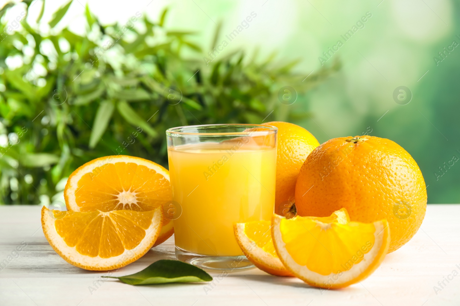 Photo of Composition with orange juice and fresh fruit on table