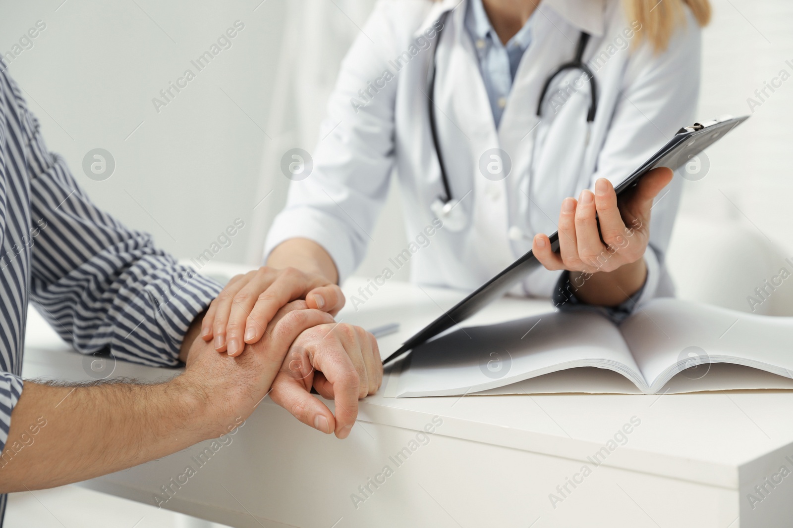 Photo of Patient having appointment with doctor in clinic, closeup