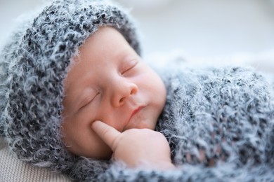 Cute newborn baby sleeping on plaid, closeup