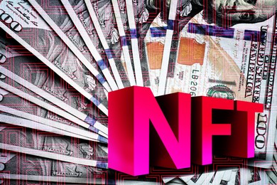 Image of Abbreviation NFT (non-fungible token) and dollar banknotes