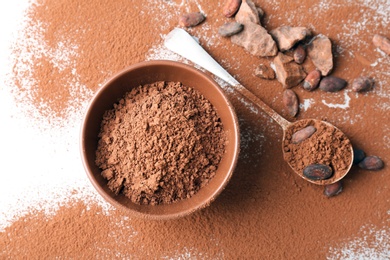 Photo of Flat lay composition with cocoa powder and beans on light background