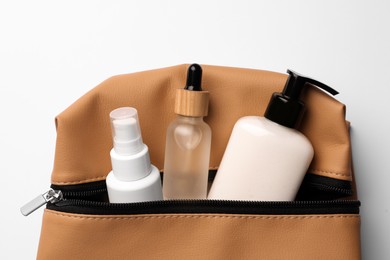 Preparation for spa. Compact bag with cosmetic products on white background, top view