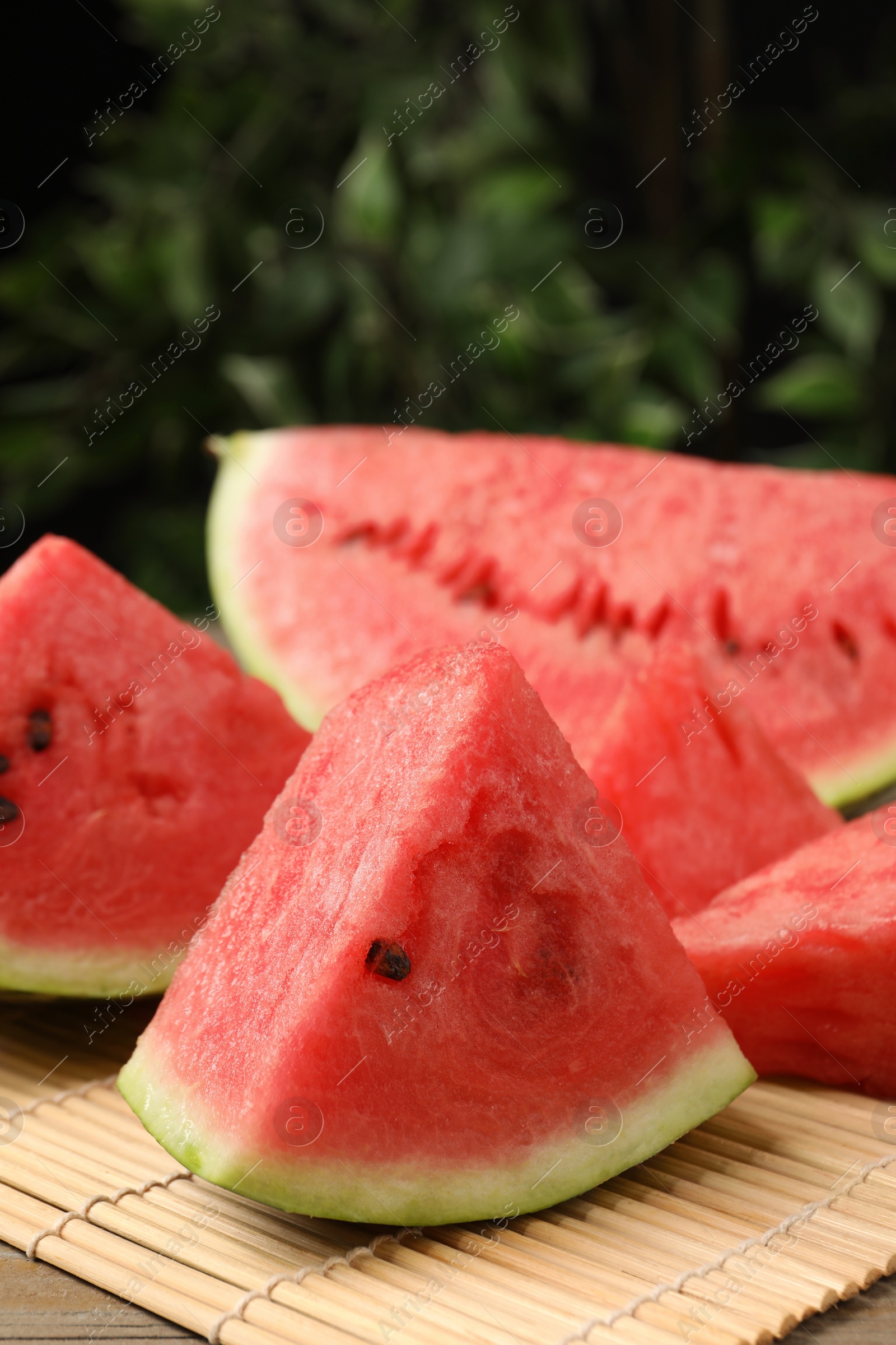 Photo of Slices of tasty ripe watermelon on wooden table