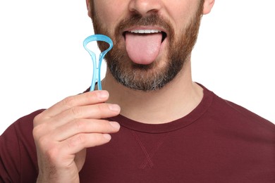 Man with tongue cleaner on white background, closeup