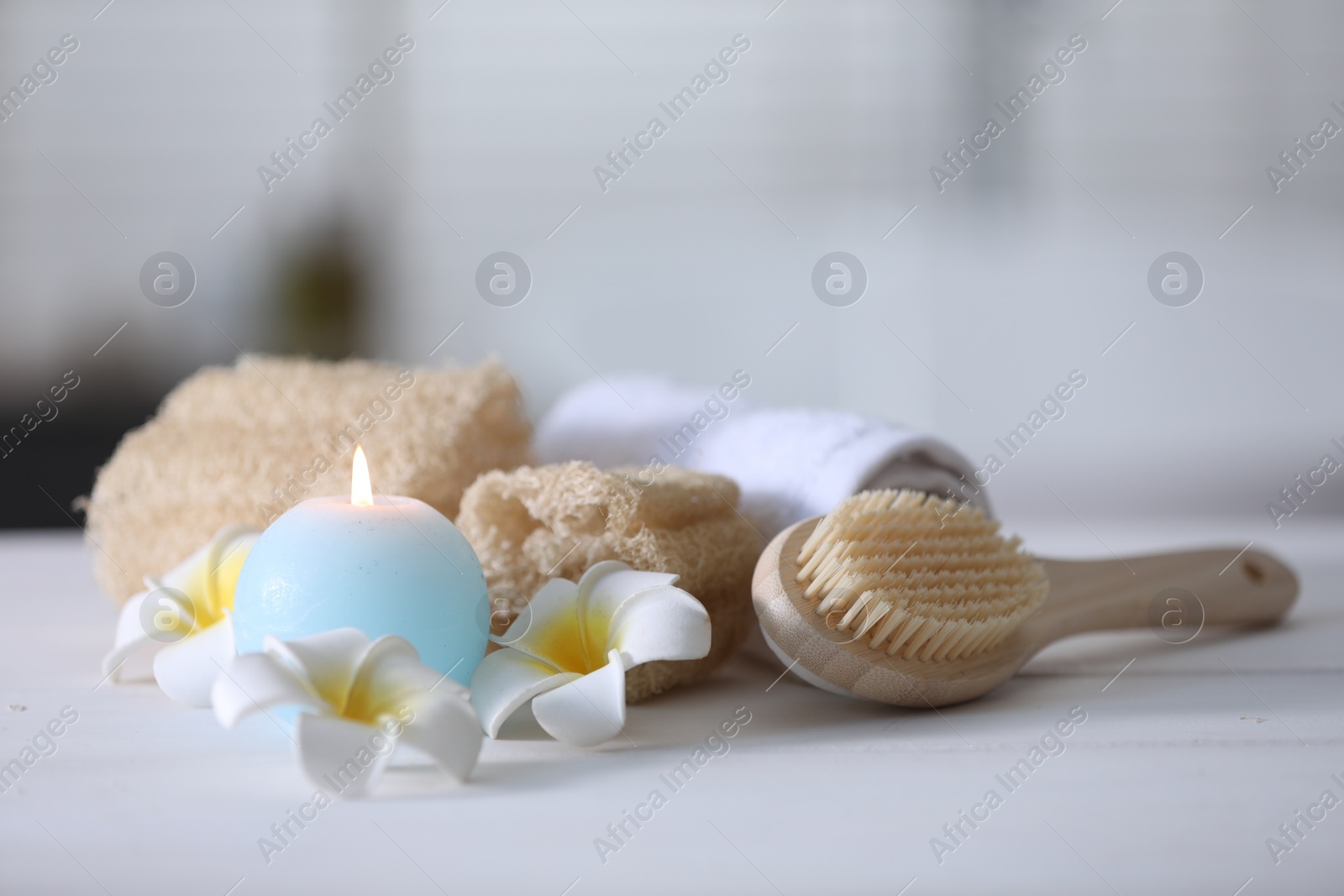 Photo of Composition with different spa supplies and flowers on white table indoors, closeup. Space for text