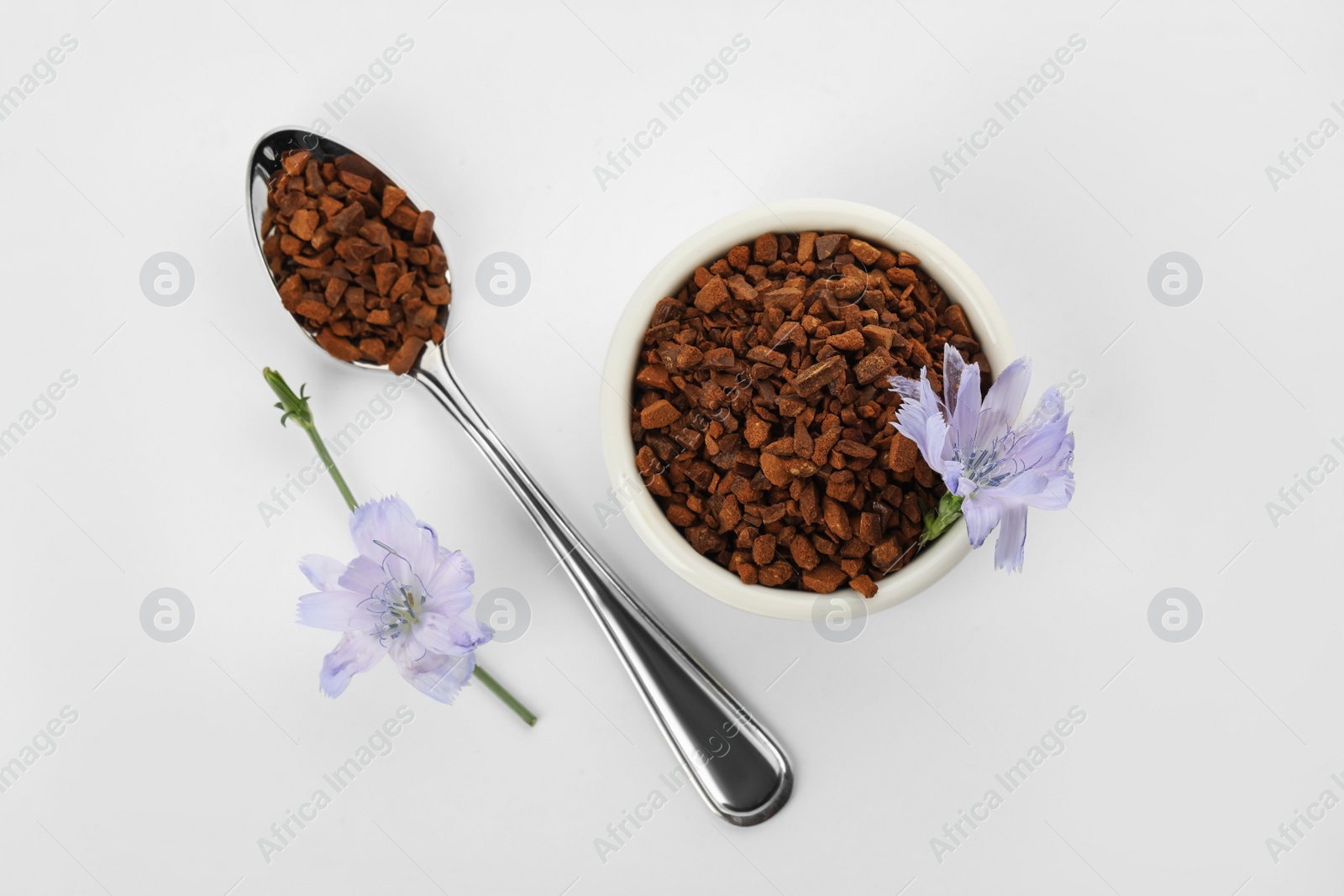 Photo of Chicory granules and flowers on white background, top view