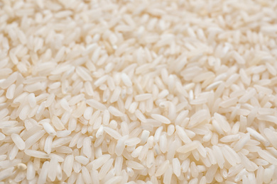 Photo of Pile of polished rice as background, closeup