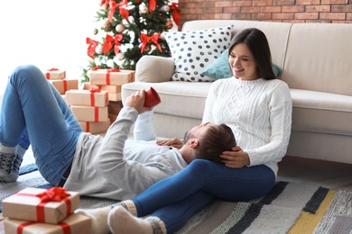 Happy young couple celebrating Christmas at home