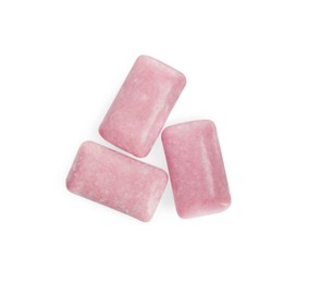 Photo of Tasty sweet chewing gums on white background, top view