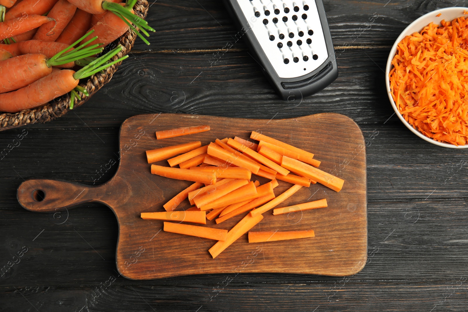 Photo of Flat lay composition with ripe carrots on kitchen table