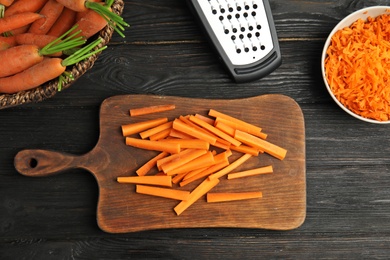 Flat lay composition with ripe carrots on kitchen table