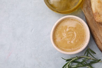 Photo of Delicious turkey gravy and rosemary on grey table, top view. Space for text