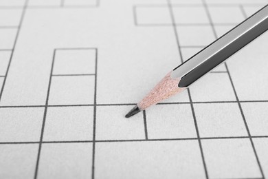Pencil and blank crossword, closeup view. Space for text
