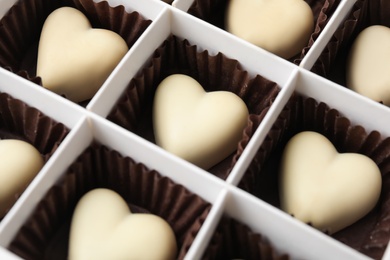 Tasty heart shaped chocolate candies in box, closeup. Valentine's day celebration