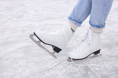 Woman wearing figure skates on ice, closeup