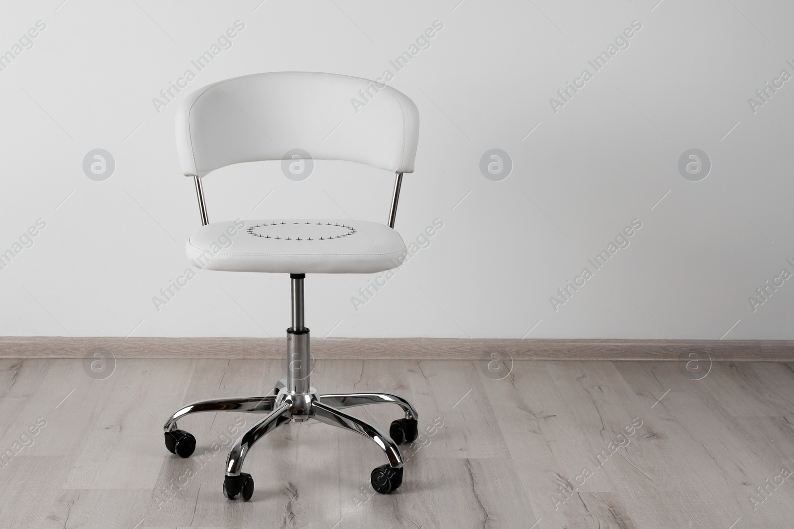 Photo of Chair with pins near white wall, space for text. Hemorrhoids concept