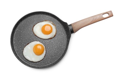 Photo of Frying pan with delicious fried eggs isolated on white, top view
