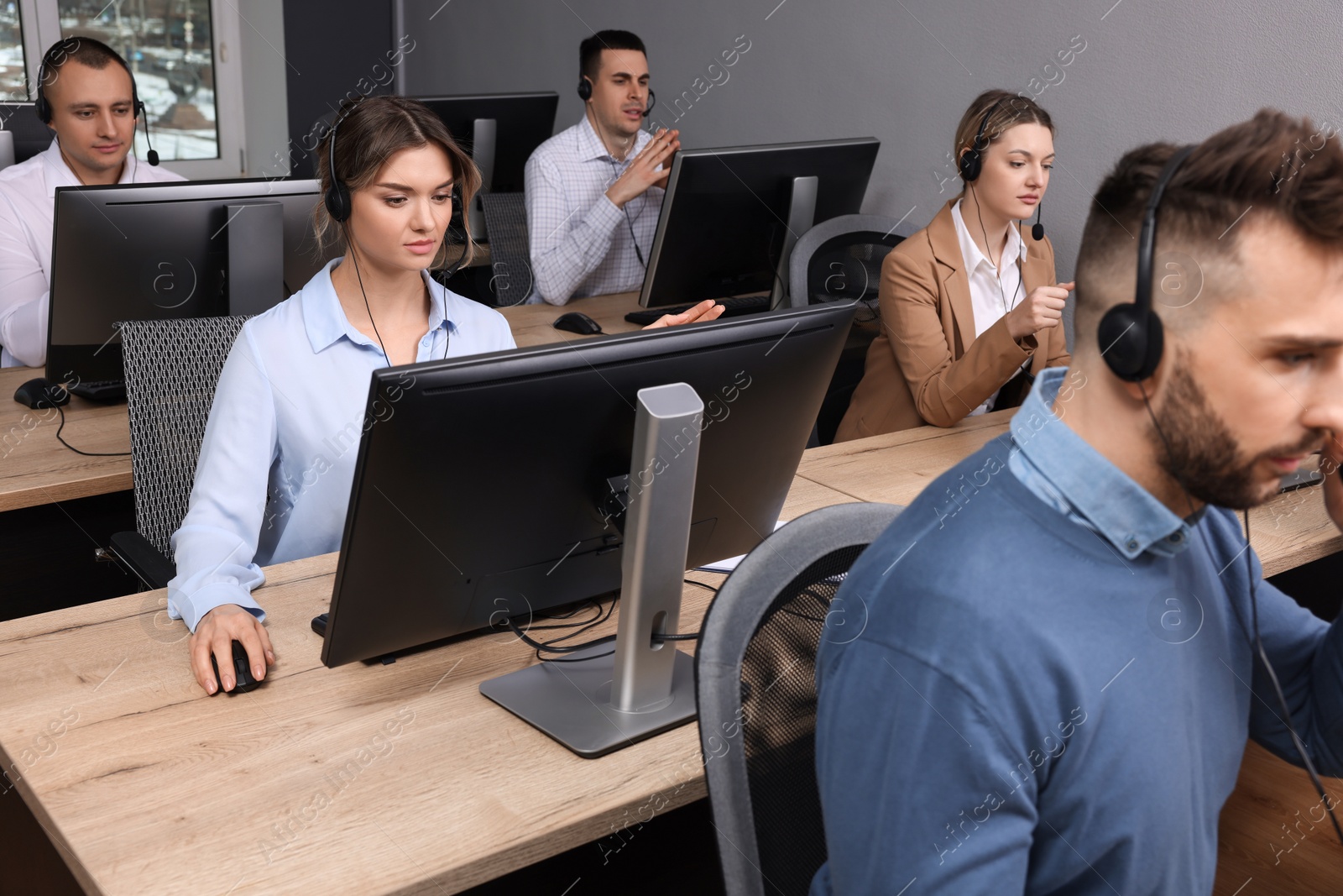 Photo of Call center operator working in modern office