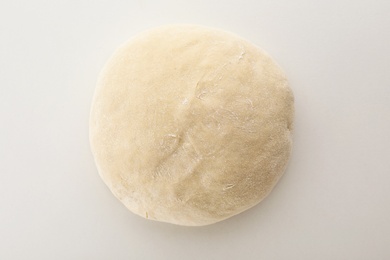 Photo of Freshly made wheat dough on white background, top view